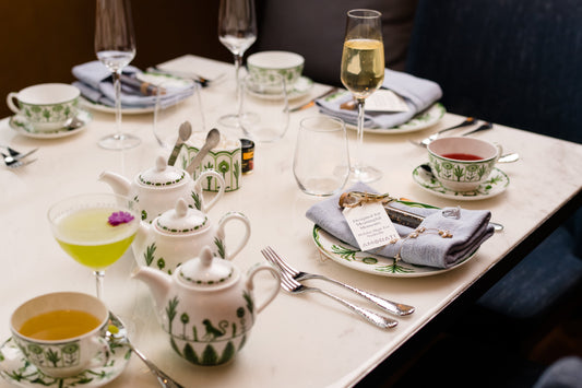 high tea table setting with diamond jewelry laid on napkin