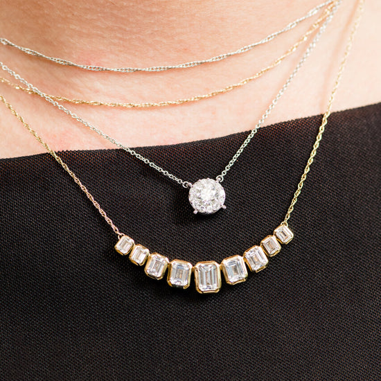 On figure 14K yellow gold amorati diamonds emery emerald cut necklace layered with Lumin Cushion Diamond Pendant Necklace.