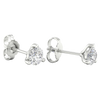 A pair of white gold or platinum stud earrings, each featuring a single brilliant-cut diamond held in a three-prong setting, displayed against a dark, transparent checkerboard background.