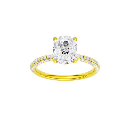 Elongated cushion-cut diamond engagement ring with a pavé-set diamond band and solitaire setting.