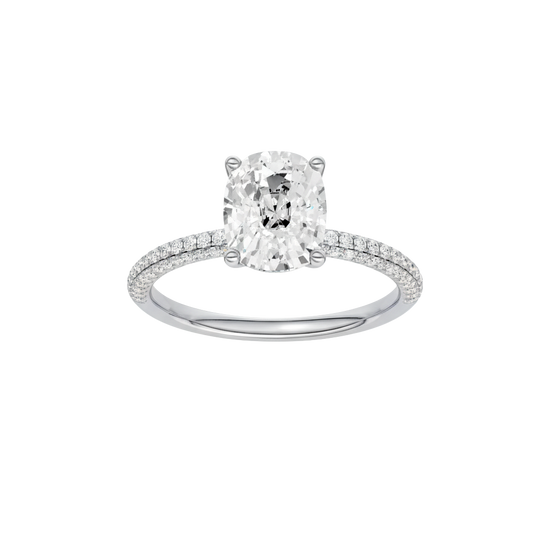 Elongated cushion-cut diamond engagement ring with a pavé-set diamond band and solitaire setting.