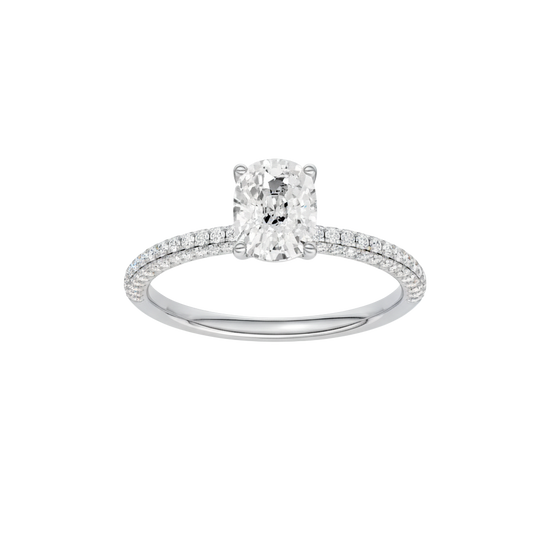 Elongated cushion-cut diamond engagement ring with a pavé-set diamond band and solitaire setting.