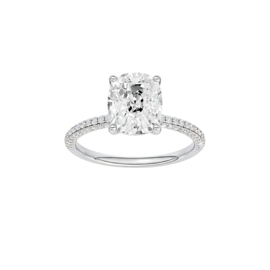 Elongated cushion-cut diamond engagement ring with a pavé-set diamond band and solitaire setting.