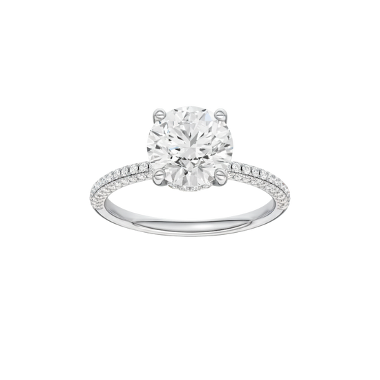 Round-cut diamond engagement ring with a pavé-set diamond band and hidden-halo setting.