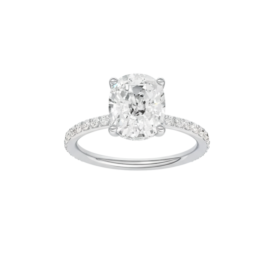 Elongated cushion-cut diamond engagement ring with a prong-set diamond band and hidden-halo setting.