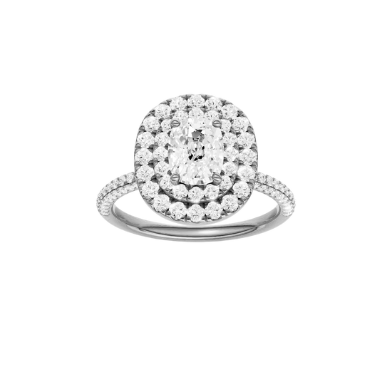 Elongated cushion-cut diamond engagement ring with a pavé-set diamond band and double-halo setting.