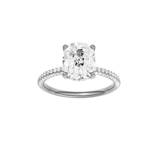 Elongated cushion-cut diamond engagement ring with a pavé-set diamond band and hidden-halo setting.