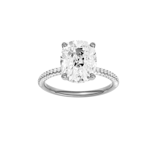 Elongated cushion-cut diamond engagement ring with a pavé-set diamond band and hidden-halo setting.