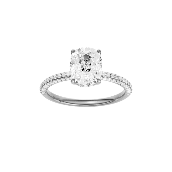 Elongated cushion-cut diamond engagement ring with a pavé-set diamond band and hidden-halo setting.