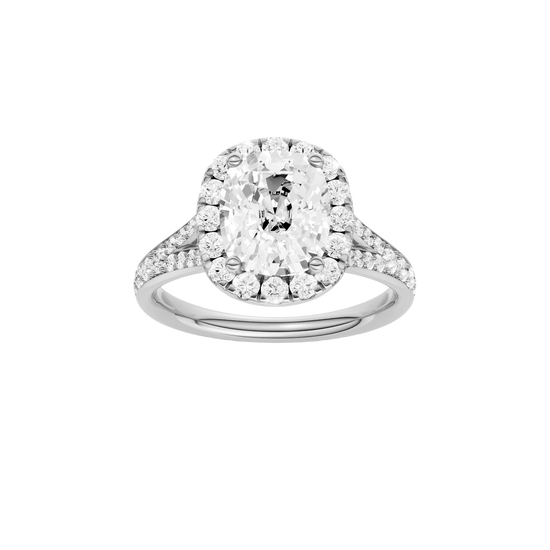 Elongated cushion-cut diamond engagement ring with a channel-set diamond band and halo setting.