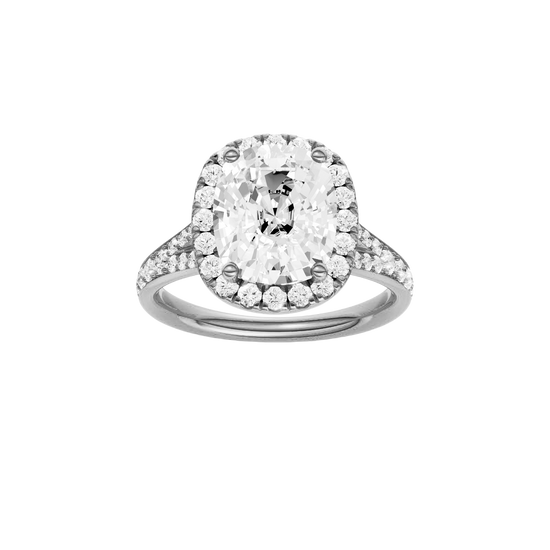 Elongated cushion-cut diamond engagement ring with a channel-set diamond band and halo setting.