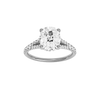 Elongated cushion-cut diamond engagement ring with a prong-set diamond band and hidden-halo setting.