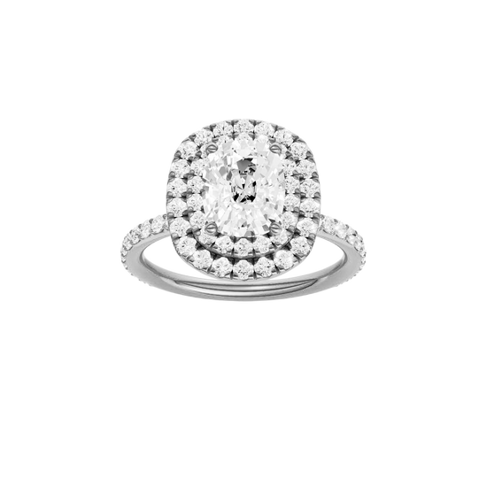 Elongated cushion-cut diamond engagement ring with a prong-set diamond band and double-halo setting.