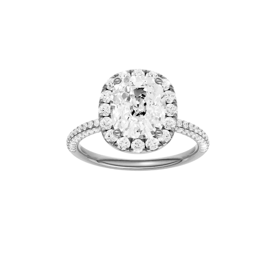 Elongated cushion-cut diamond engagement ring with a pavé-set diamond band and halo setting.