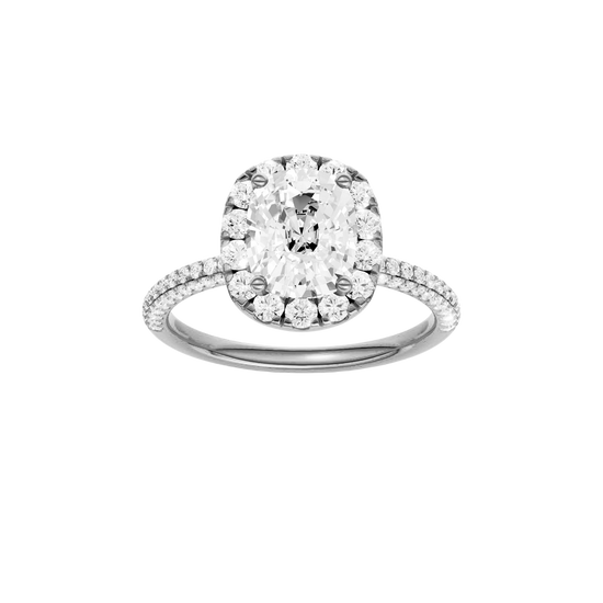 Elongated cushion-cut diamond engagement ring with a pavé-set diamond band and halo setting.
