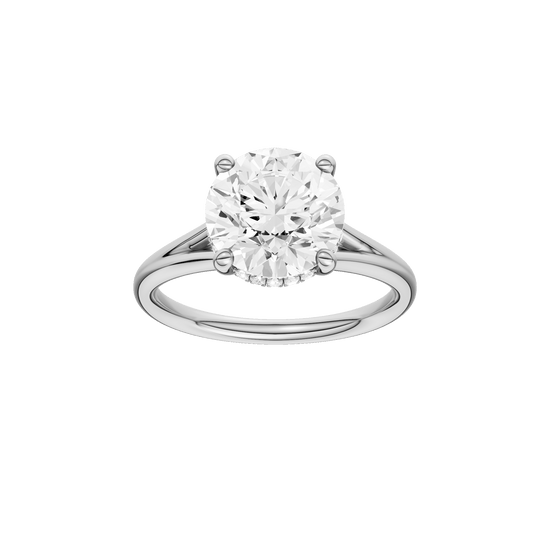 Round-cut diamond engagement ring with a plain band and hidden-halo setting.