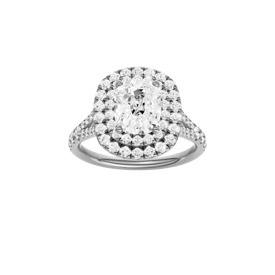 Elongated cushion-cut diamond engagement ring with a prong-set diamond band and double-halo setting.