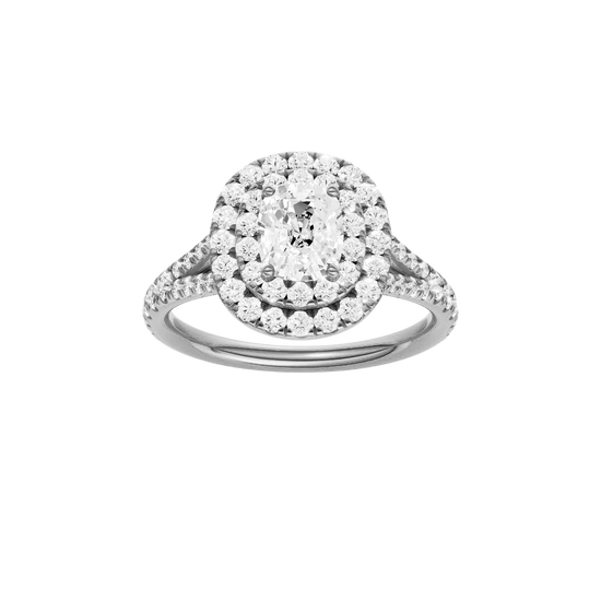 Elongated cushion-cut diamond engagement ring with a prong-set diamond band and double-halo setting.