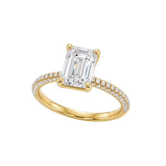 A three-quarter view of the Emerald cut diamond engagement ring in 14k yellow gold with a prong diamond band and cathedral setting