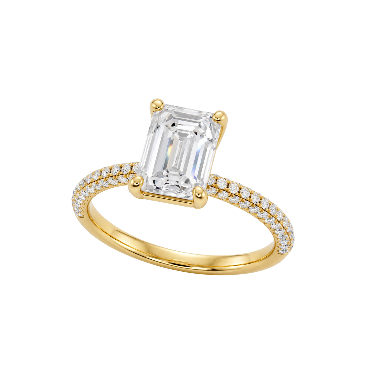 A three-quarter view of the Emerald cut diamond engagement ring in 14k yellow gold with a prong diamond band and cathedral setting
