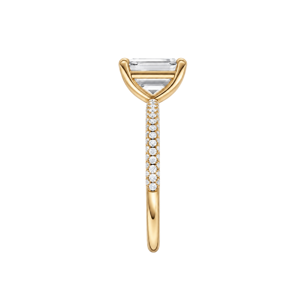 A side view of the Emerald cut diamond engagement ring in 14k yellow gold with a prong diamond band and cathedral setting