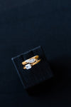 Amorati Diamonds Asymmetrical Horizontal Stacking Ring stacked with Whispering Signet Ring on a layflat.