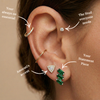 Close up of ear stacking the cascade baguette-emerald stud, prism studs and lumiere martini diamond studs.