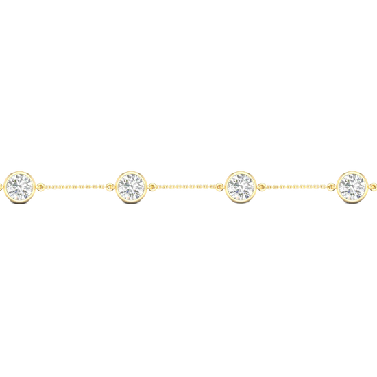 A close-up side view of a 14K yellow gold bracelet, showing a series of bezel-set diamonds connected by a delicate chain.