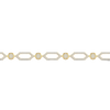 A close-up side view of a 14K yellow gold geometric bracelet, showing the interconnected hexagonal links with pavé diamonds and a bezel-set center stone.