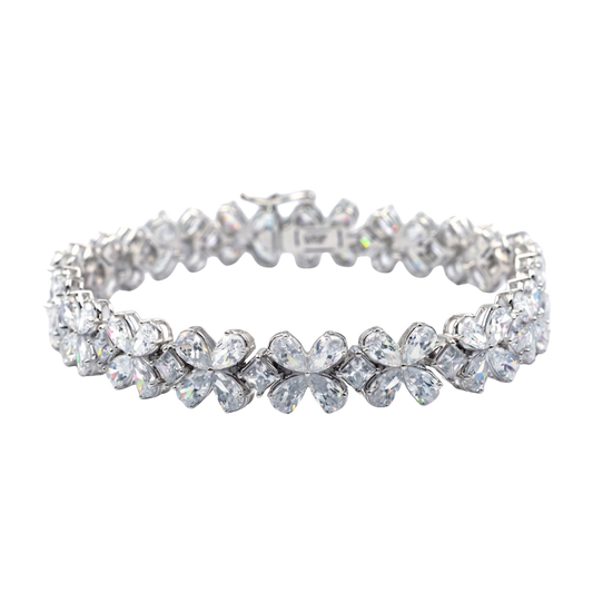 Front view of a diamond floral tennis bracelet in white gold, featuring marquise and round diamonds arranged in repeating flower-inspired clusters with a flexible, high-polish setting.
