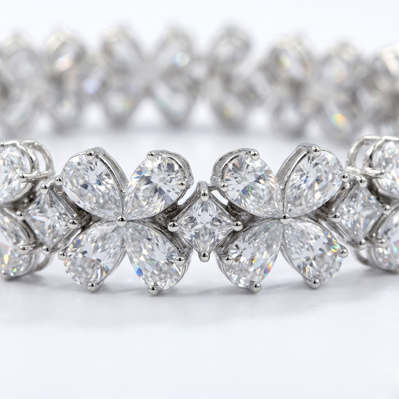 Close-up detail of the Amorati Signature 17-Carat Diamond Tennis Bracelet in white gold, featuring alternating pear-cut diamond floral clusters and square-cut diamonds.
