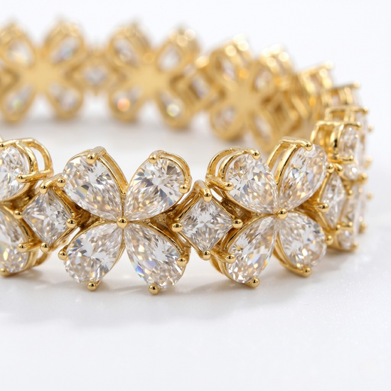 Close-up detail of the Amorati Signature 17-Carat Diamond Tennis Bracelet in yellow gold, featuring alternating pear-cut diamond floral clusters and square-cut diamonds.