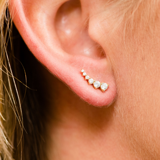 Amorati Diamonds 14K white gold delicate diamond climber earring with a line of graduated pavé diamonds, shown on a model.