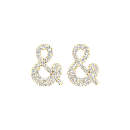 A pair of 14K yellow gold stud earrings shaped like an ampersand and covered in pavé diamonds, shown from the front.