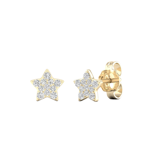 An angled view of a pair of 14K yellow gold star-shaped stud earrings with pavé diamonds, showcasing the full design.