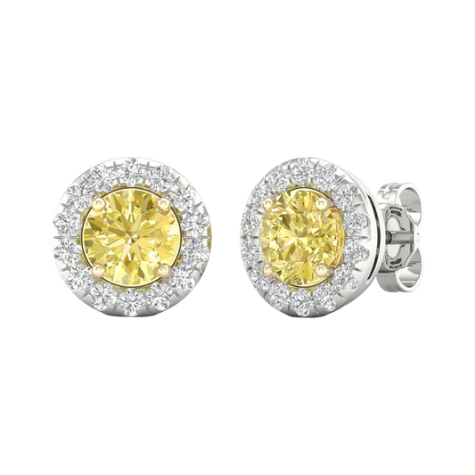 An angled view of a pair of 14K white gold stud earrings, with a with a 2 carat total weight VS+  yellow diamond at the center and a halo of white diamonds, showcasing the full design.