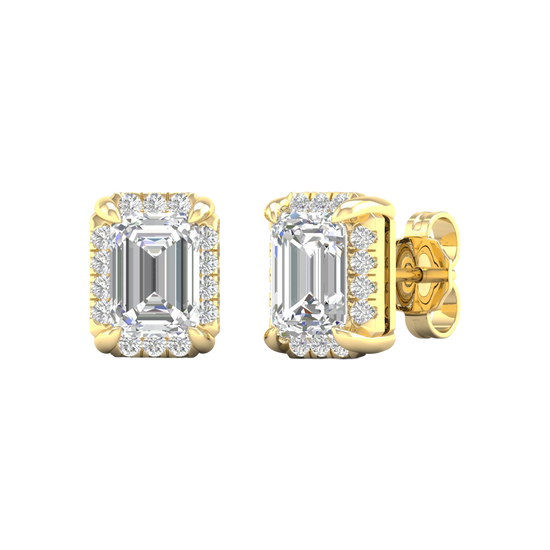 Angled view of yellow gold emerald-cut halo diamond stud earrings highlighting warm gold tones, precise facets, and dimensional halo sparkle.