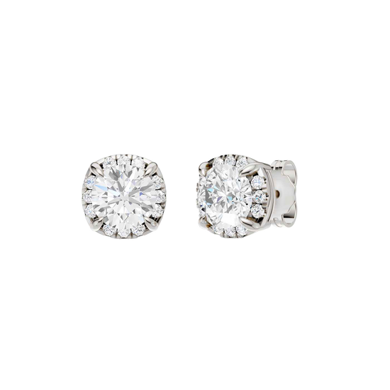 Angled view of white gold round halo diamond stud earrings highlighting center stone brilliance, halo sparkle, and polished metal finish.