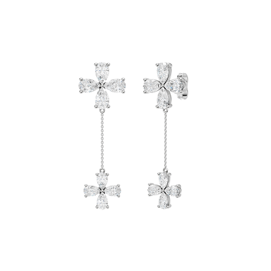 Angled view of white gold floral diamond drop earrings highlighting the dimensional flower design, articulated movement, and diamond brilliance.
