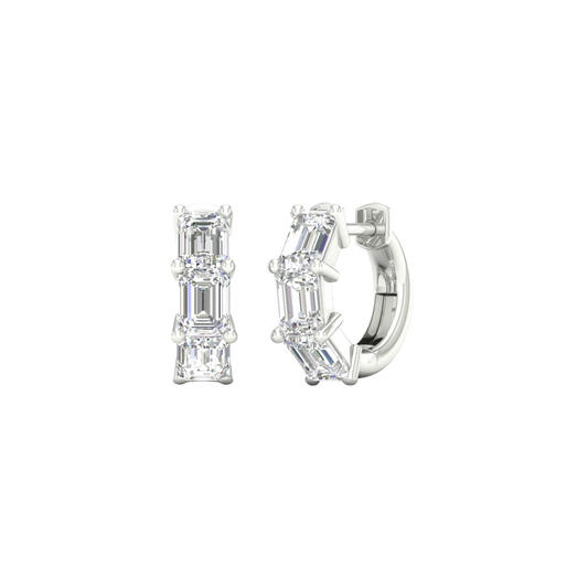 An angled view of a pair of 14K white gold huggie hoops, showcasing the linear design of the diamonds.