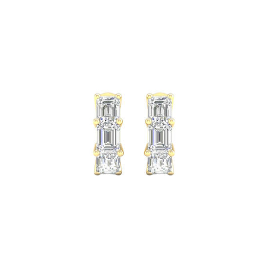 A close-up view of a 14K yellow gold huggie hoop earring with three vertically stacked rectangular diamonds.