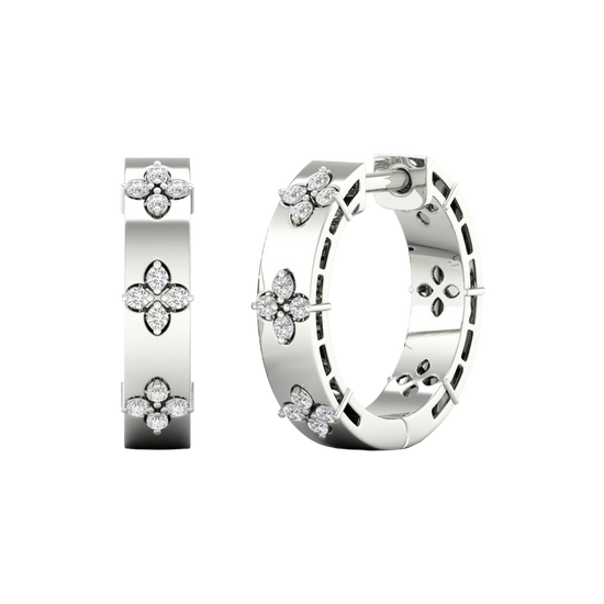 A pair of 14K white gold huggie hoop earrings with diamond clover accents from the Amorati Collection, displayed in both front and angled views to showcase the intricate design and thickness.