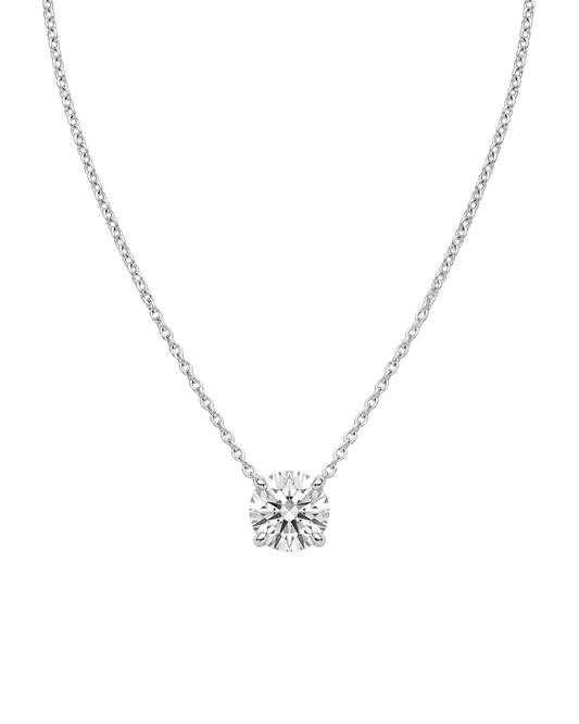 Product shot of a delicate silver-tone chain necklace featuring a brilliant round-cut clear gemstone in a four-prong setting, displayed against a white background.