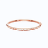 Amorati Diamond Multishape Studded Thin Bangle is a slim 14K rose gold bracelet with a row of stamped shapes inset with round lab grown diamonds on a plain white background.