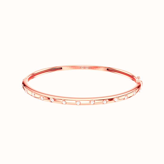 Amorati Diamonds Multi Shape Studded Diamond Stackable Bangle. This slim 14K rose gold bangle bracelet with a row of various shapes stamped into the gold with round lab grown diamond inset in each shape, shown on a plain white background. 