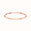 Amorati Diamonds Multi Shape Studded Diamond Stackable Bangle. This slim 14K rose gold bangle bracelet with a row of various shapes stamped into the gold with round lab grown diamond inset in each shape, shown on a plain white background. 
