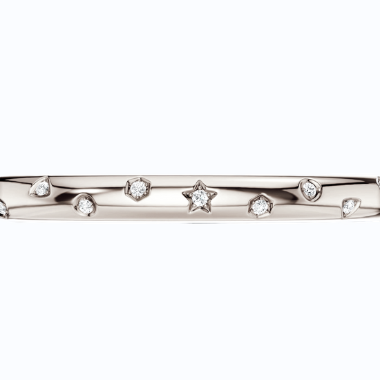 Amorati Diamonds Multi Shape Studded Diamond Bangle in 14K white gold. The bracelet featuring a row of small star, triangles and other shapes inset with round lab grown diamonds, shown against a plain white background.