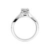 A side profile view of 14K white gold Amorati Vignette emerald diamond solitaire with prong setting and diamond band