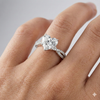 Heart cut diamond engagement ring in 14k white gold with a prong diamond band and twist setting on a hand