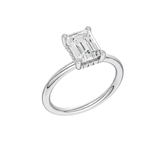 A three-quarter view of the Emerald cut diamond engagement ring in 14k white gold with a plain band and solitaire setting